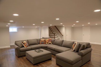 Basement - large traditional laminate floor and brown floor basement idea in New York with beige walls