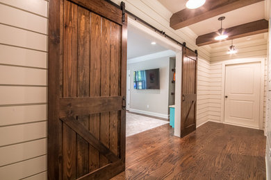 Example of a small cottage look-out dark wood floor and brown floor basement design in Atlanta with white walls and no fireplace