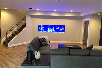 Example of a large minimalist look-out light wood floor and brown floor basement design in Denver with brown walls