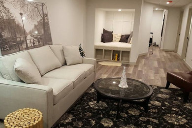 Basement - mid-sized traditional medium tone wood floor basement idea in Calgary with white walls
