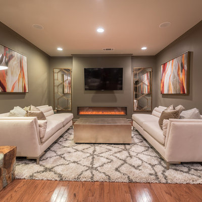 Inspiration for a transitional underground dark wood floor basement remodel in Atlanta with gray walls, a ribbon fireplace and a metal fireplace