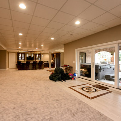 Inspiration for a huge contemporary walk-out carpeted and beige floor basement remodel in Chicago with beige walls
