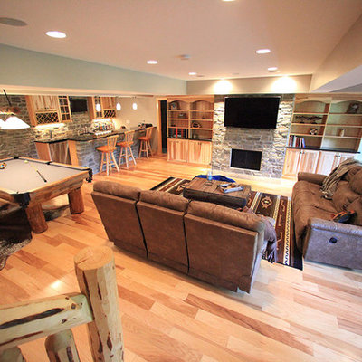 Large mountain style underground light wood floor basement photo in Philadelphia with blue walls, a stone fireplace and a standard fireplace