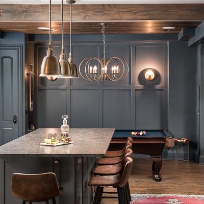 Mid-sized mountain style look-out vinyl floor and brown floor basement photo in Chicago with gray walls, a standard fireplace and a stone fireplace