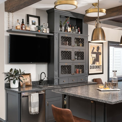 Basement - mid-sized rustic look-out vinyl floor and brown floor basement idea in Chicago with gray walls, a standard fireplace and a stone fireplace