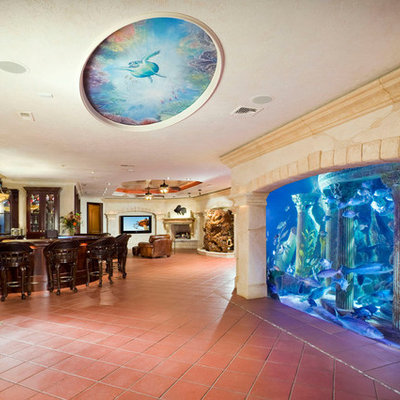 Tuscan underground terra-cotta tile and red floor basement photo in New York with beige walls and a standard fireplace