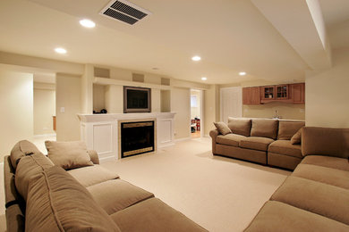 Inspiration for a mid-sized timeless underground carpeted and beige floor basement remodel in Philadelphia with yellow walls, a standard fireplace and a plaster fireplace