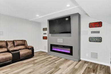 Mid-sized minimalist underground vinyl floor and gray floor basement photo in St Louis with gray walls and a standard fireplace
