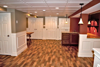 Basement game room - large transitional underground carpeted, gray floor and vaulted ceiling basement game room idea in Philadelphia with gray walls, a hanging fireplace and a metal fireplace