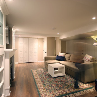 Basement - mid-sized traditional underground brown floor and dark wood floor basement idea in Ottawa with beige walls, a standard fireplace and a brick fireplace