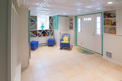 Example of a beach style walk-out ceramic tile basement design in Boston with green walls and no fireplace