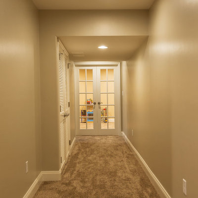 Inspiration for a timeless carpeted basement remodel in Philadelphia with beige walls and no fireplace