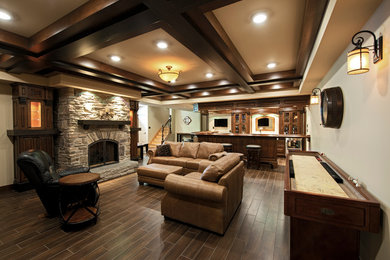Inspiration for a large timeless underground ceramic tile basement remodel in Ottawa with beige walls, a standard fireplace and a stone fireplace