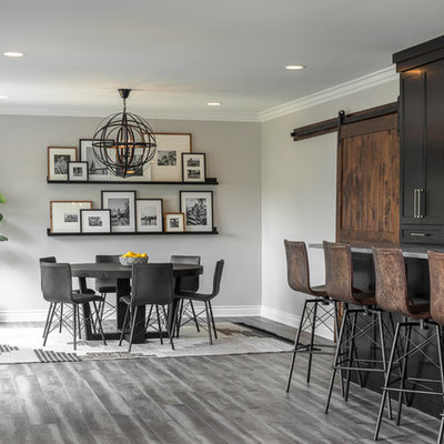 Example of a large transitional walk-out vinyl floor and gray floor basement design in Detroit with gray walls