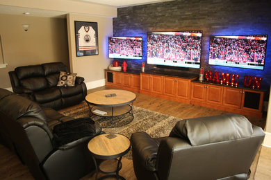 Basement - large eclectic walk-out medium tone wood floor and brown floor basement idea in Edmonton with beige walls and no fireplace