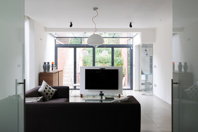 Medium sized contemporary basement in London with ceramic flooring and grey floors.