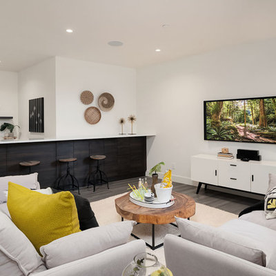 Trendy underground brown floor basement photo in Seattle with white walls and no fireplace
