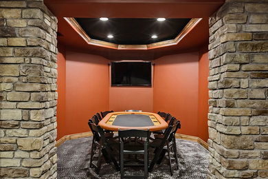 Example of a mid-sized classic underground carpeted and gray floor basement design in Denver with orange walls and no fireplace