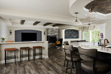 Example of a large transitional walk-out vinyl floor and gray floor basement design in Minneapolis with gray walls, a stone fireplace and a corner fireplace