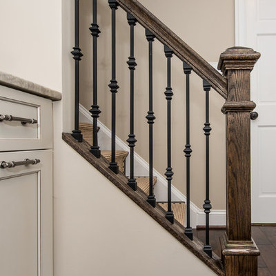 Example of a mid-sized classic underground dark wood floor and brown floor basement design in DC Metro with beige walls and a standard fireplace