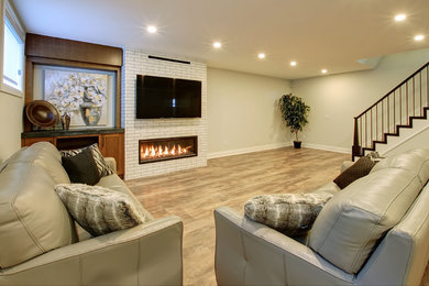 Basement - mid-sized transitional look-out basement idea in Toronto with white walls, a ribbon fireplace and a brick fireplace