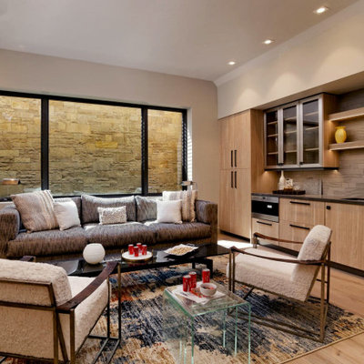 Example of a mountain style look-out light wood floor basement design in Denver with beige walls and no fireplace
