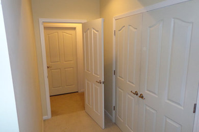 This is an example of a large classic fully buried basement in Indianapolis with beige walls, carpet and no fireplace.