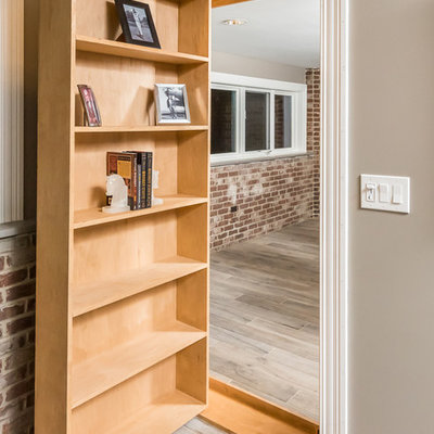 Inspiration for a large industrial look-out medium tone wood floor and brown floor basement remodel in Chicago with gray walls and no fireplace