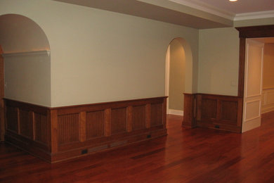 Example of a mid-sized trendy underground medium tone wood floor basement design in Detroit with green walls and no fireplace