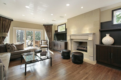 Example of a large trendy walk-out laminate floor and brown floor basement design in Providence with beige walls, a standard fireplace and a stone fireplace