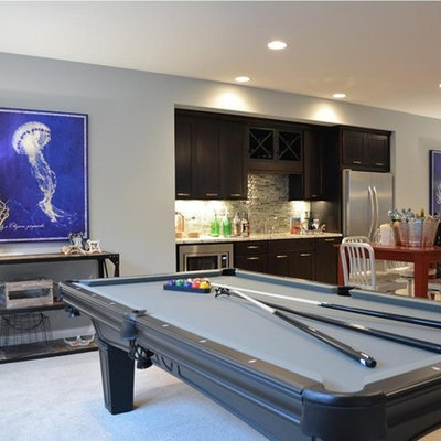Example of a transitional underground carpeted basement design in Indianapolis with gray walls and no fireplace