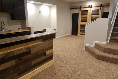 Example of a large mountain style underground carpeted and brown floor basement design in Indianapolis with beige walls and no fireplace
