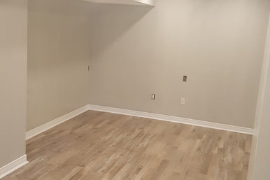 Example of a mid-sized minimalist basement design in Ottawa