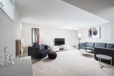 Design ideas for a large modern look-out basement in Toronto with grey walls, carpet and a standard fireplace.