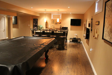 Mid-sized elegant look-out medium tone wood floor basement photo in Toronto with beige walls and no fireplace