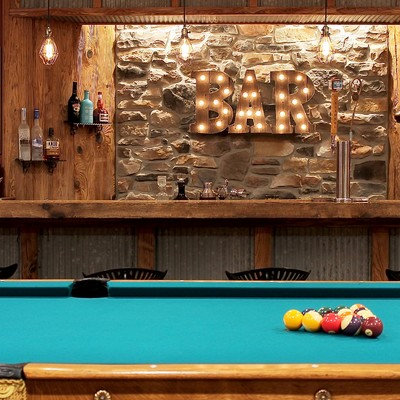 Basement - mid-sized rustic underground concrete floor and beige floor basement idea in Philadelphia with brown walls