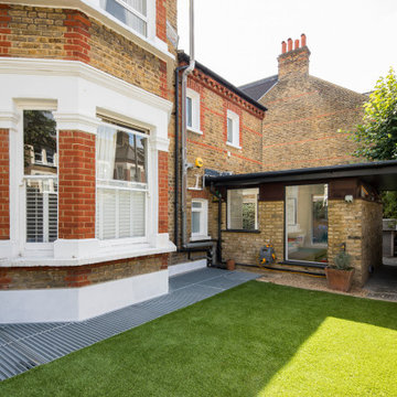 Side extension and light-wells to basement