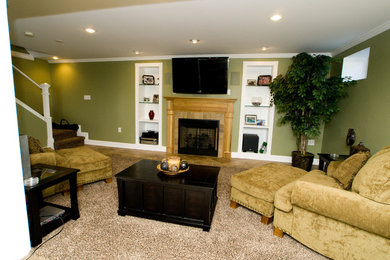 This is an example of a medium sized classic walk-out basement in Other with green walls, porcelain flooring, a wooden fireplace surround and brown floors.