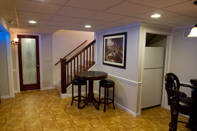 Mid-sized minimalist basement photo in Kansas City with beige walls