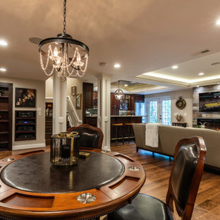 Inspiration pour un grand sous-sol design donnant sur l'extérieur avec salle de cinéma, une cheminée standard, un sol marron, un plafond décaissé et boiseries.