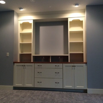Urbandale basement with built in cabinets.