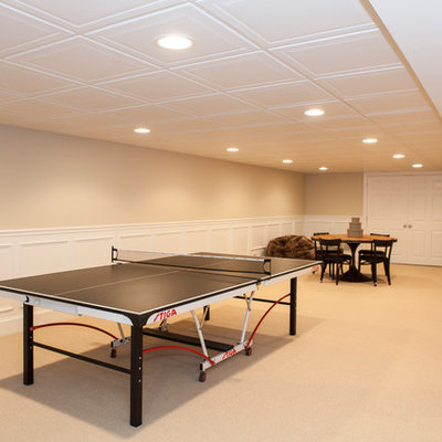 Inspiration for a large timeless underground carpeted basement remodel in Philadelphia with beige walls