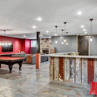 Example of a large classic look-out ceramic tile and gray floor basement design in Chicago with red walls, a standard fireplace and a stone fireplace