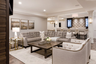 Basement - transitional underground vinyl floor and brown floor basement idea in Detroit with gray walls, a two-sided fireplace and a wood fireplace surround