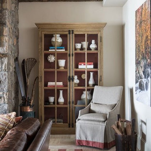 Cette photo montre un grand sous-sol chic donnant sur l'extérieur avec un mur beige, un sol en calcaire et une cheminée standard.