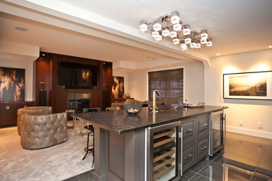 Example of a trendy walk-out basement design in Calgary with a standard fireplace