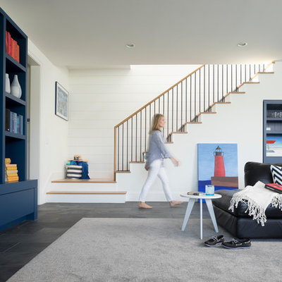 Beach style gray floor basement photo in Minneapolis with white walls