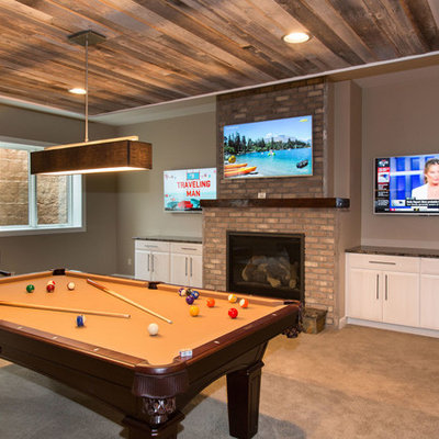 Mid-sized transitional underground carpeted basement photo in Other with beige walls, a standard fireplace and a brick fireplace