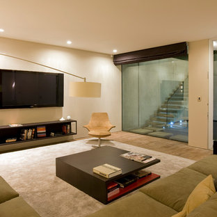 Photo of a medium sized modern look-out basement in London with beige walls, light hardwood flooring and brown floors.