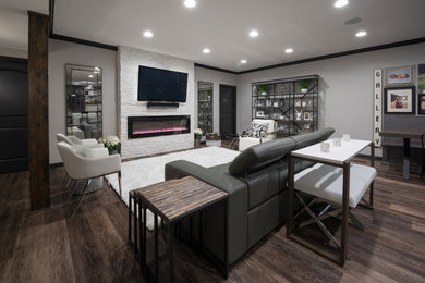 Inspiration for a large craftsman underground laminate floor basement remodel in Indianapolis with gray walls, a stone fireplace and a ribbon fireplace